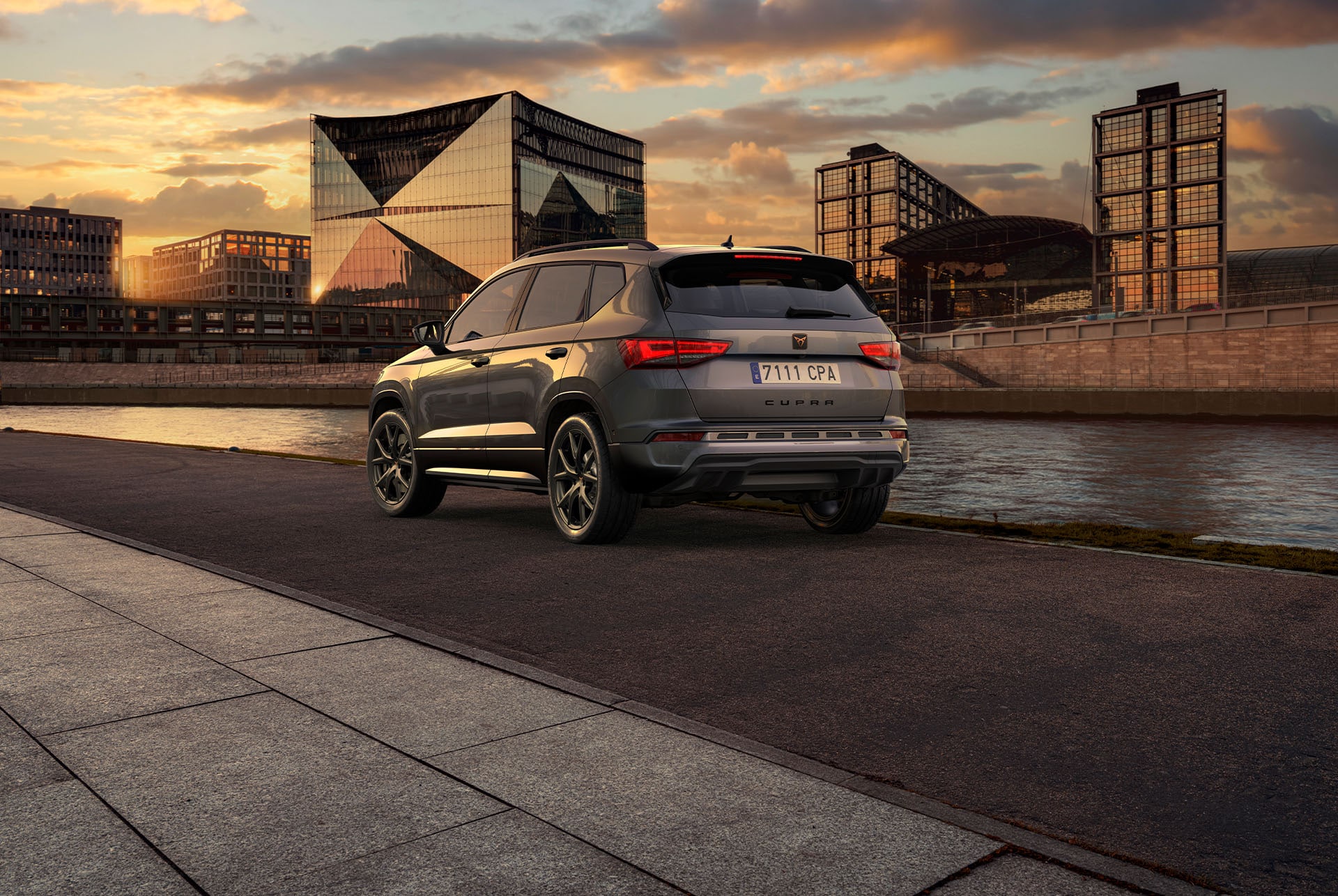 A person walking towards a CUPRA Ateca, showcasing the car's bold, athletic lines and dynamic form, representing the CUPRA tribe's spirit. 