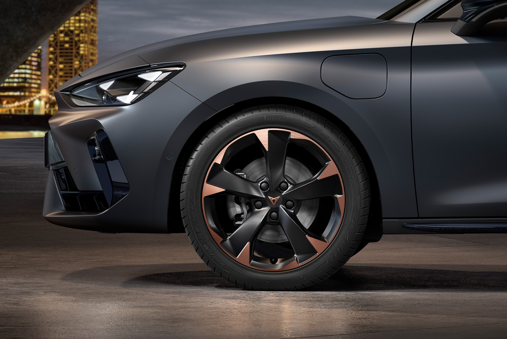 front side view of left mistral garbi copper machined alloy wheels for the new cupra leon sportstourer 2025, tyres, signature headlights and grey body