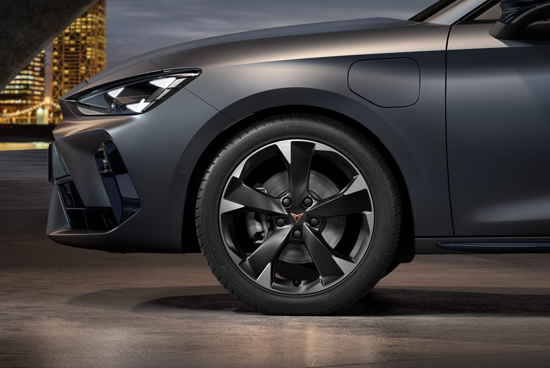 front side view of left machined silver garbi alloy wheel for the new cupra leon sportstourer 2025, tyres, signature headlights and grey body