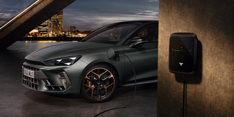 plug in hybrid electric vehicle with remote charging capabilities plugged into a wall charger